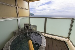A hot tub with a view of the ocean.