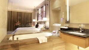 A modern hotel room with a large bed, a wooden vanity with a sink, and a large mirror. - Shuidu Holiday Hotel (Shenzhen)