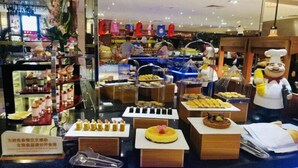 A buffet with various food items and a mascot. - Shuidu Holiday Hotel (Shenzhen)