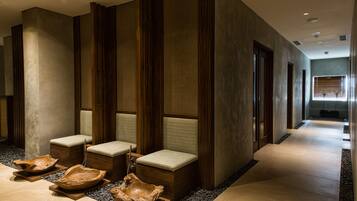 A modern spa area with wooden benches and bowls.