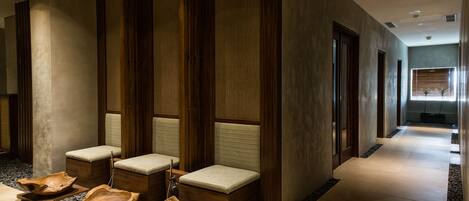 A modern spa area with wooden benches and bowls.