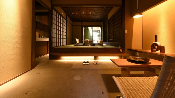 A traditional Japanese room with tatami flooring, a low table with a tray, and a sliding door leading to a garden. - Kuraya Kiyomizu-Gojo (Kyoto)