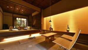 A modern interior with a wooden bench, a table, and a hanging light fixture. - Kuraya Kiyomizu-Gojo (Kyoto)
