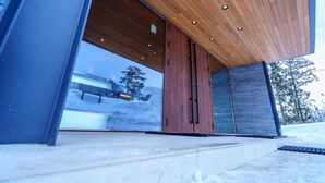 A modern building with large glass windows, wooden ceiling, and a snowy outdoor area. - Mountainside Hakuba (Hakuba)