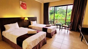 A hotel room with two beds, a balcony with chairs, and a TV. - Amverton Heritage Resort (Malacca City)