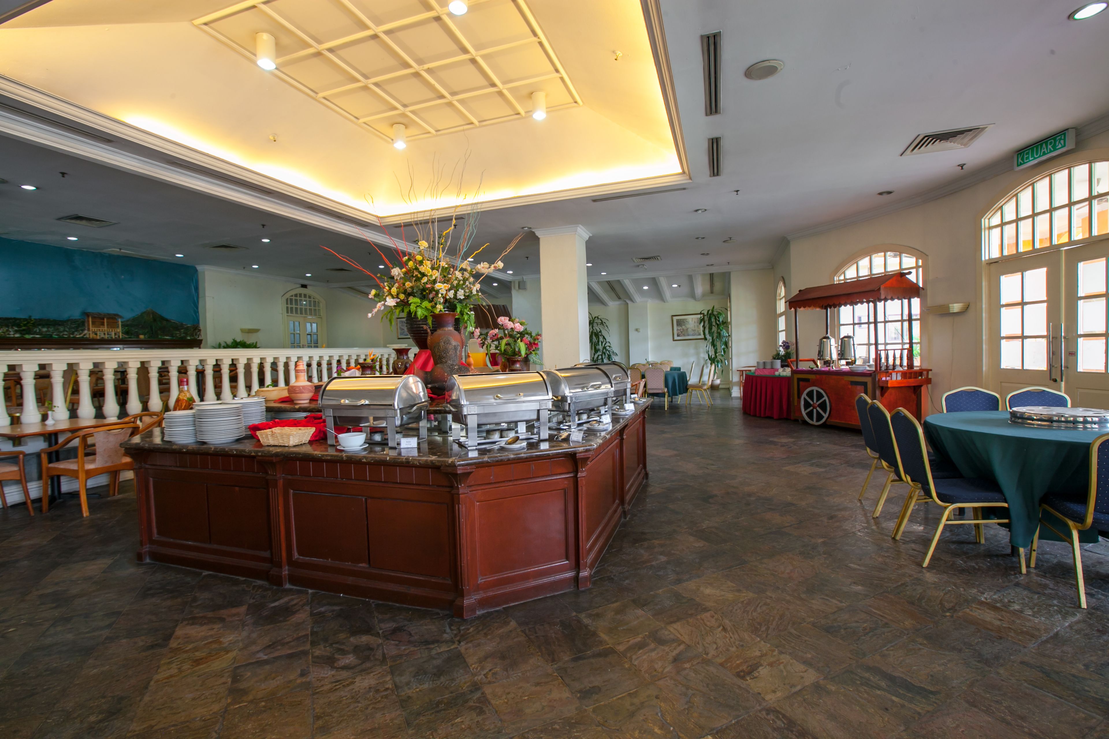 A buffet area with a central island, seating arrangements, and a large window providing natural light.