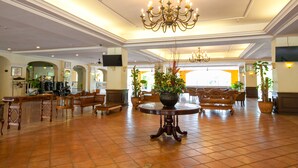 A spacious lobby with a large chandelier, multiple seating areas, and potted plants. - Amverton Heritage Resort (Malacca City)
