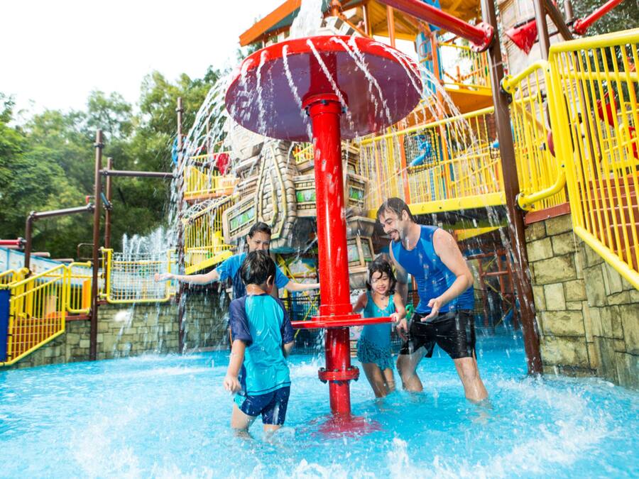 A water park with a central water feature and a play structure.