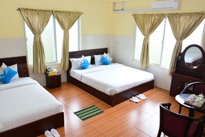 A hotel room with two beds, a small table with a tray of tea cups, a mirror, and a chair. - Hotel 99 (Pyin Oo Lwin)
