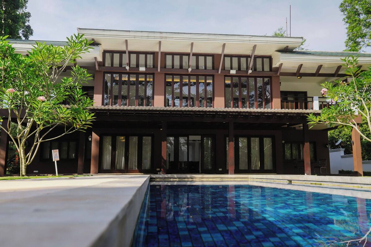 A two-story building with a swimming pool in front.