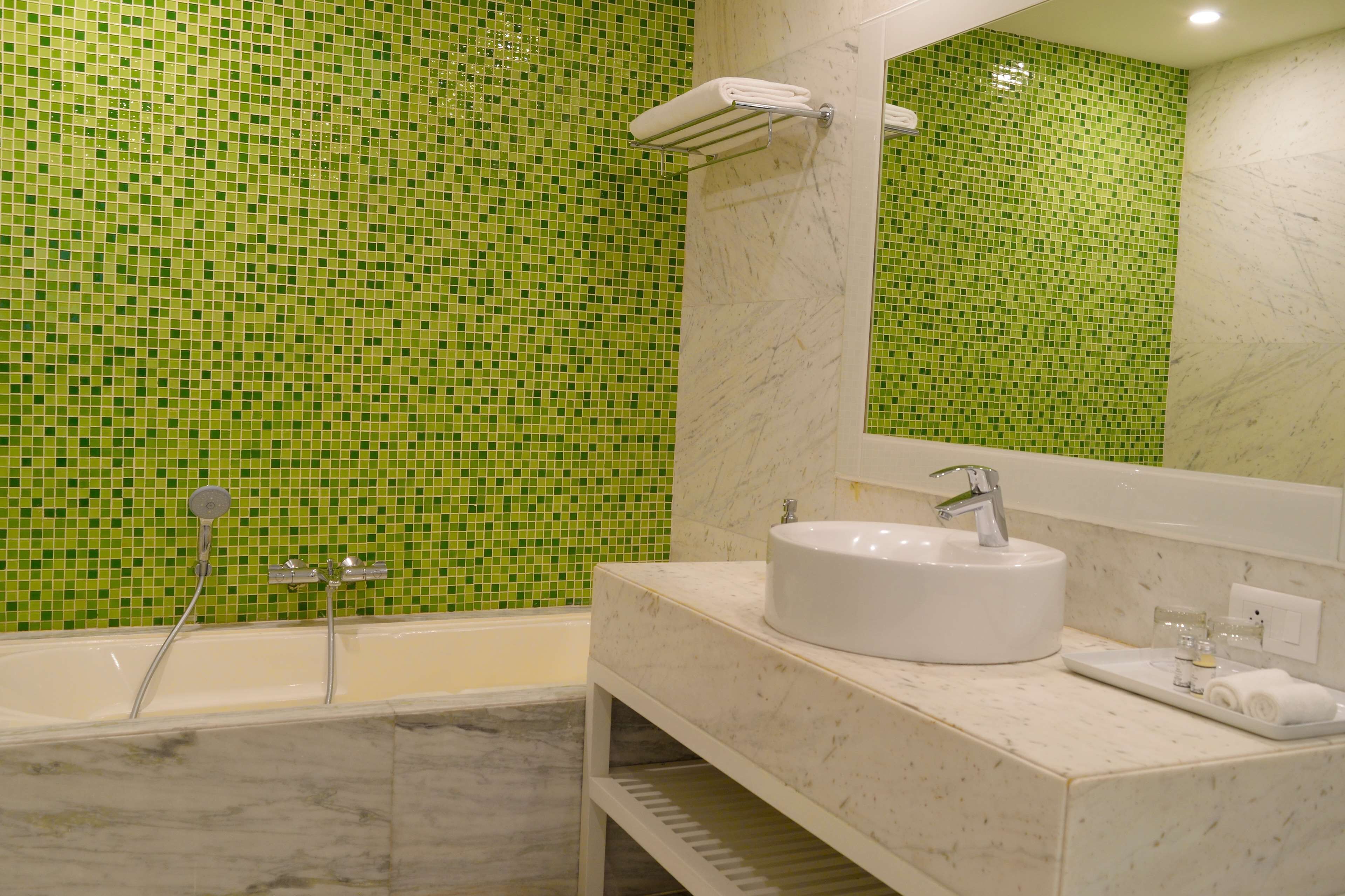 deluxe room, multiple beds, balcony | bathroom | separate bathtub and shower, rainfall showerhead, free toiletries