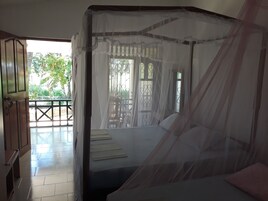 Standard Triple Room | Living area | Flat-screen TV