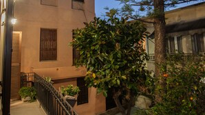 A building with a balcony, a tree, and a railing. - Maya's Residence (Rethymno)