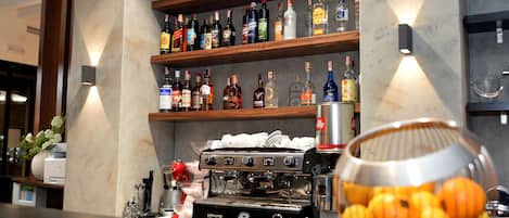 A bar area with shelves of liquor bottles, a coffee machine, and a fruit bowl.