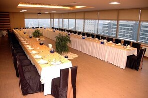 Conference room with a long table, city views, and modern design.