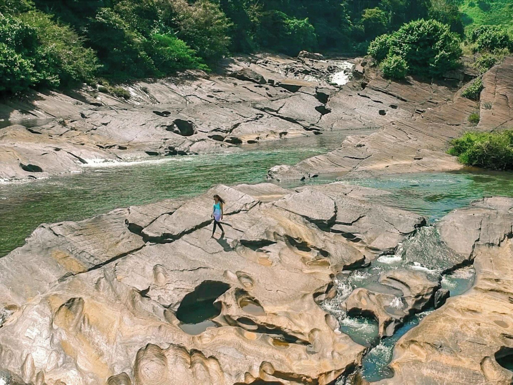 A rocky landscape with a river flowing through it.
