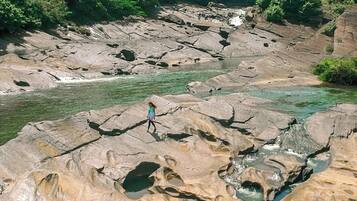 A rocky landscape with a river flowing through it.