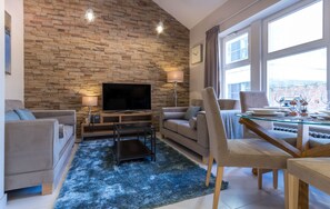 Apartamento executivo, 1 quarto, cozinha | Sala de estar | TV de tela plana