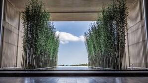 A modern architectural structure with vertical lines and a water feature in the center. - The Sanya EDITION (Sanya)