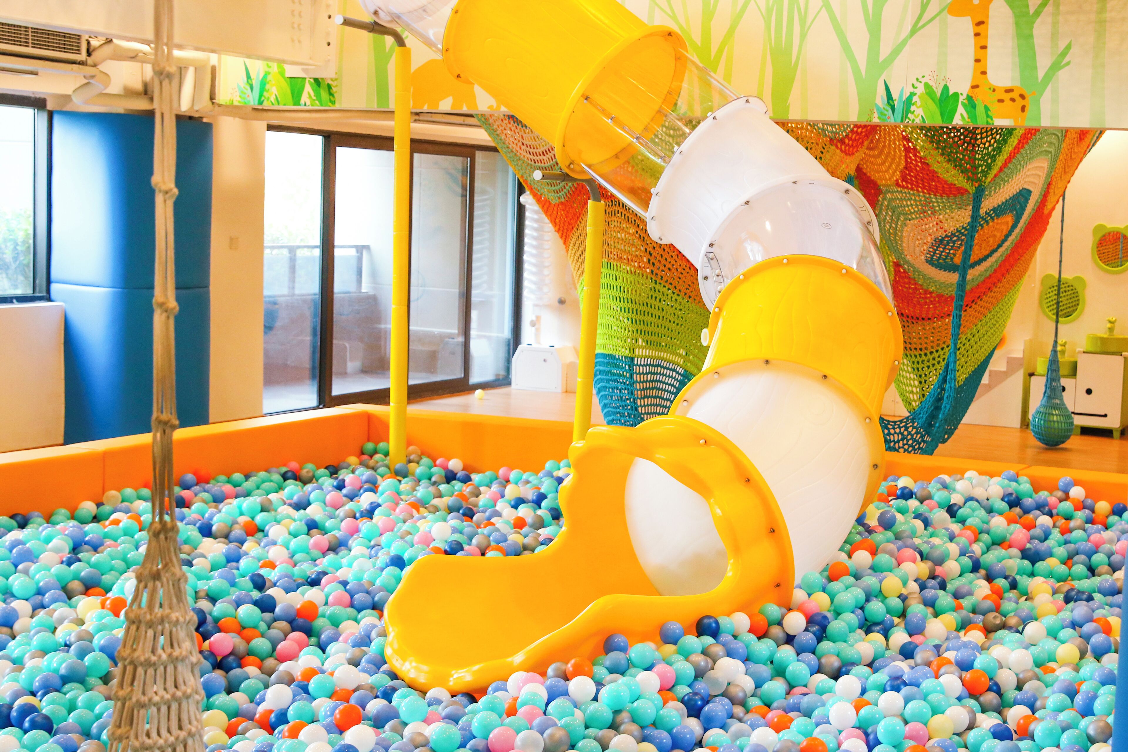 A children's play area with a ball pit and a slide.