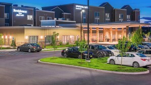 A modern hotel with a covered entrance, multiple parking spaces, and a well-maintained lawn. - Residence Inn by Marriott Fishkill (Fishkill)