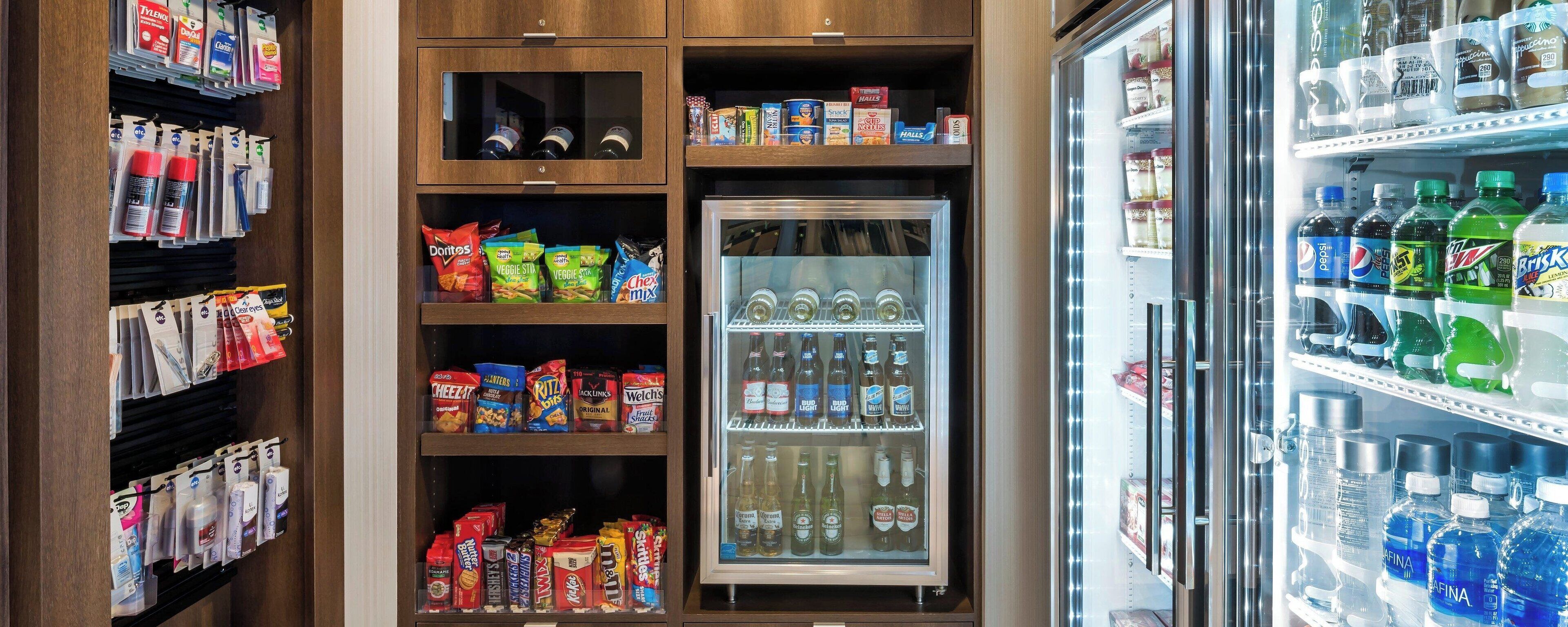 A vending machine stocked with snacks and beverages, including Doritos, Veggie Stix, and various sodas.