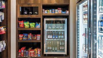 A vending machine stocked with snacks and beverages, including Doritos, Veggie Stix, and various sodas.