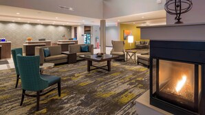 A spacious lobby with a fireplace, seating areas, and a reception desk. - Residence Inn by Marriott Fishkill (Fishkill)