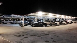 A parking lot with multiple cars and a covered structure. - Chansuda Lake View Hotel (Ubon Ratchathani)