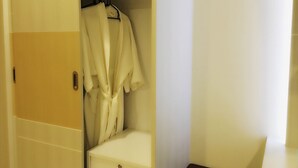 A hotel room with a wardrobe, a bed, and a small bedside table. - Chansuda Lake View Hotel (Ubon Ratchathani)