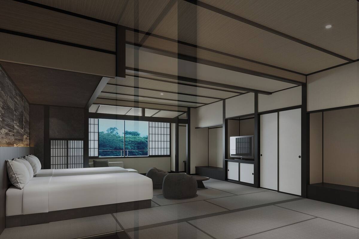 Ein modernes Schlafzimmer mit einem großen Bett, einem Fernseher und Schiebetüren.