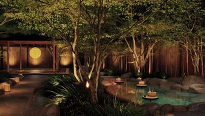 A serene indoor garden with a wooden structure, a koi pond, and a traditional Japanese lantern. - Gensen Itto Minamiizu (Minamiizu)