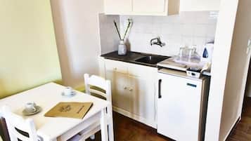 Triple Room, Garden View | Private kitchenette | Fridge, electric kettle