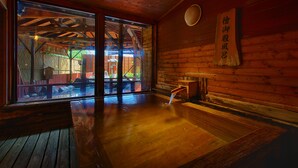 A wooden interior with a large sliding glass door leading to an outdoor area. - Atagawa Prince Hotel (Higashiizu)