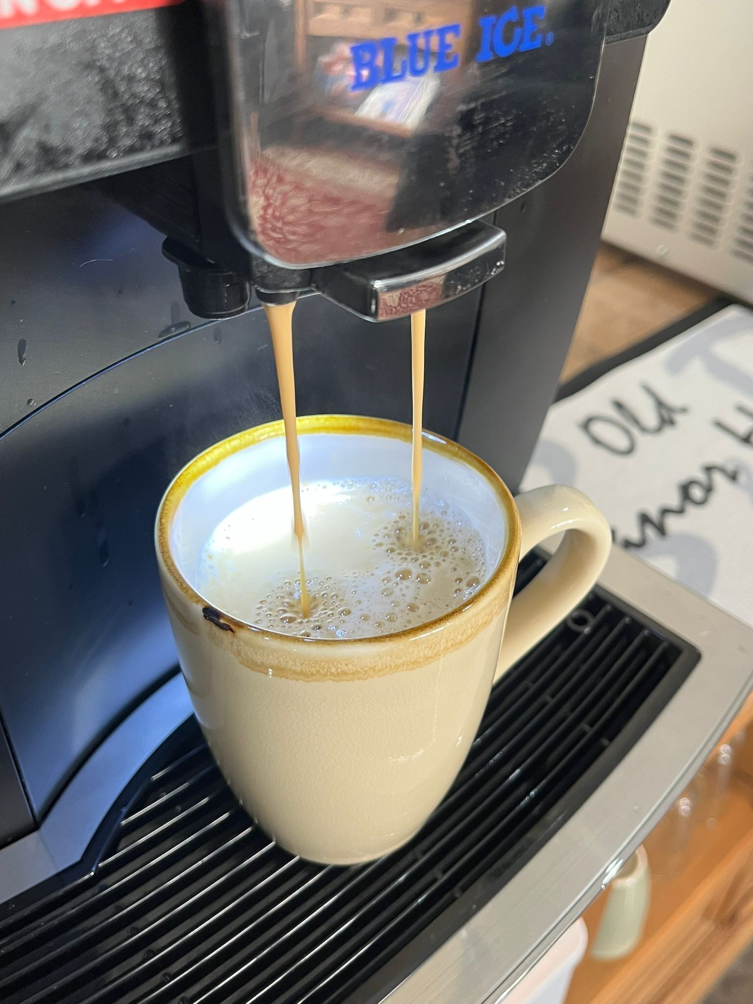 A coffee machine dispensing coffee into a cup.