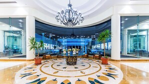 A lobby with a central floral arrangement, a chandelier, and a circular floor design. - Siva Sharm Resort & Spa  (Sharm El Sheikh)