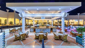 An outdoor patio area with wicker furniture, a bar, and a tiled floor. - Siva Sharm Resort & Spa  (Sharm El Sheikh)