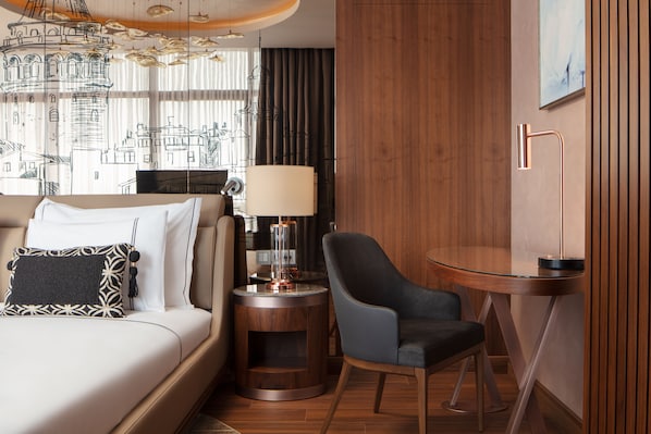 A modern hotel room with a bed, a chair, a round table, and a lamp. - Lionel Hotel Istanbul (Istanbul)