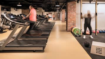 A gym with treadmills, a punching bag, and weightlifting equipment.