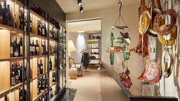 A wine cellar with shelves of wine bottles and a decorative fish sculpture.