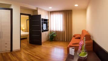Junior Suite, Bathtub, Tower | Living area | 32-inch flat-screen TV with cable channels, TV
