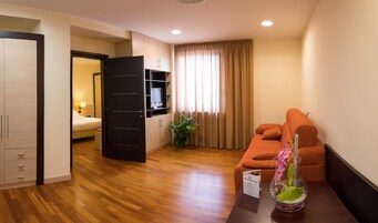 Junior Suite, Tower | Living area | 32-inch flat-screen TV with cable channels, TV