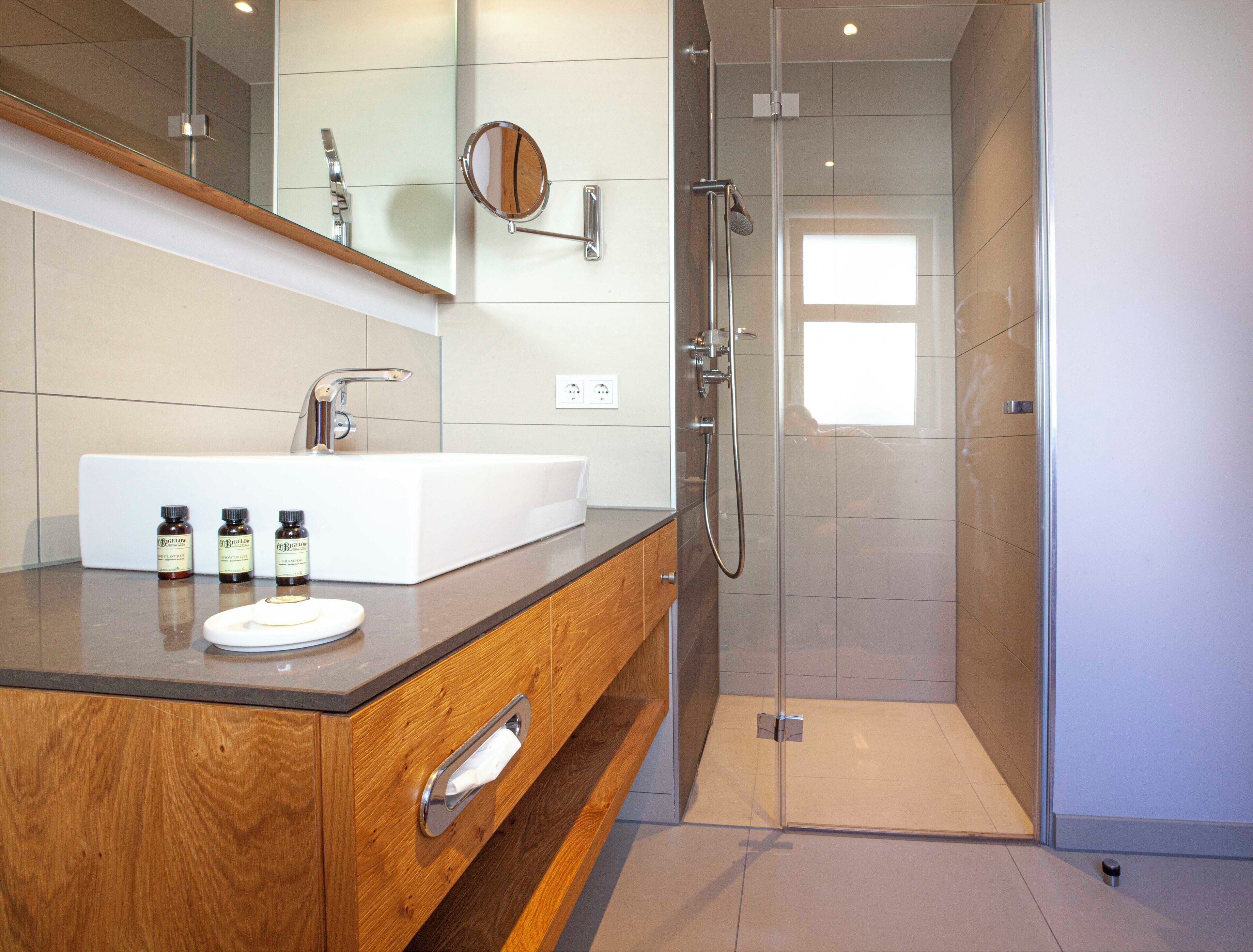 deep-soaking bathtub, rainfall showerhead, designer toiletries