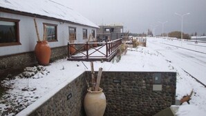 A building with a stone wall and a wooden fence.
