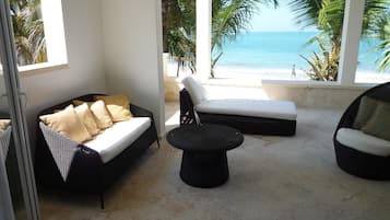 Three Bedroom Apartment, Beachfront | Living area | Flat-screen TV