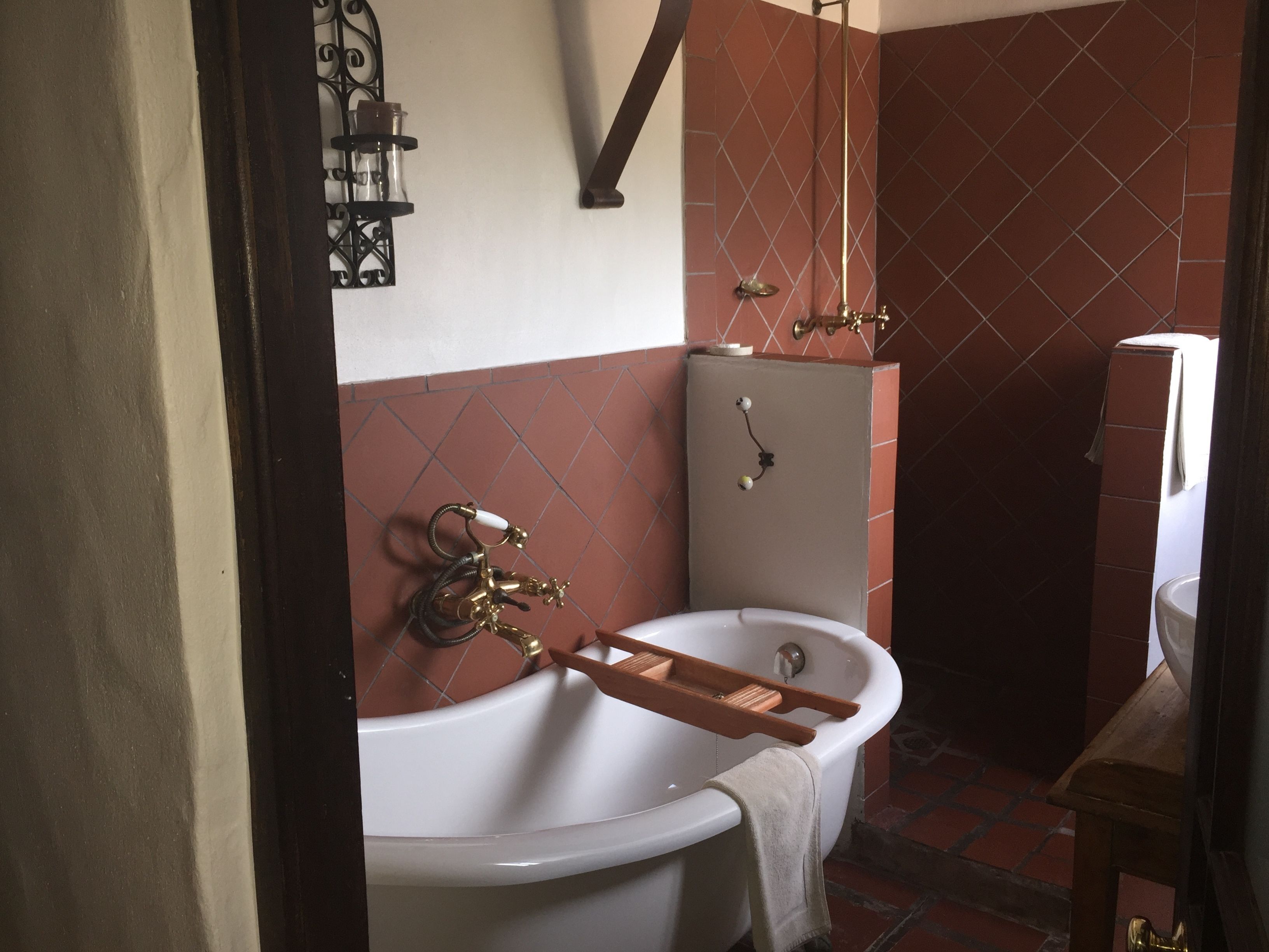 A bathroom with a freestanding bathtub, a shower with a glass door, and a toilet.