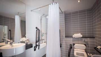 A modern bathroom with a shower, toilet, and sink.
