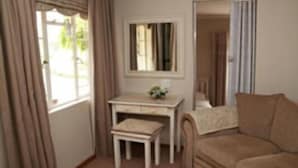 A room with a desk, a chair, and a sofa.