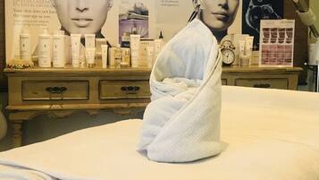 Experience soothing skincare treatments in a serene spa area with a selection of premium products and a comfortable bed.