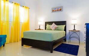 Cozy bedroom with a single bed, nightstands, and a rug.